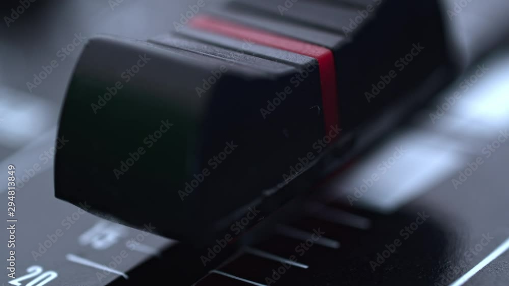 Poster rack focus of professional sound console slider, macro closeup
