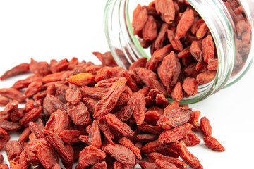 dried goji berries spilling out of glass jar