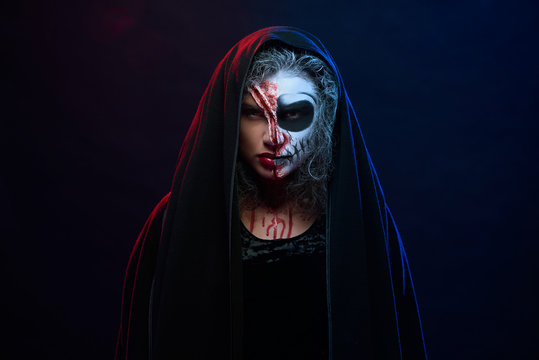 Attractive woman in halloween costume with skeleton makeup