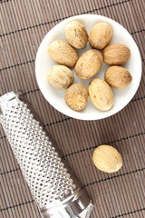 nutmeg seeds in a small white bowl