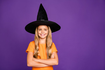 Photo of little witch lady with crossed arms playing paranormal creature halloween party wear orange t-shirt wizard hat isolated purple color background