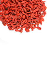 dried goji berries on a white plate food background texture with copy space
