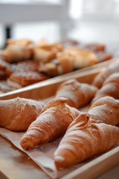 Many croissants on a wooden tray. bakery concept