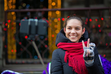 Pleased girl taking self portrait in winter