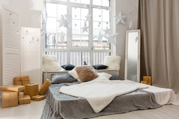 White and grey master bedroom with large windows and double bed