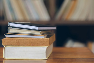 Close-up of books stacked on the old wooden table in library