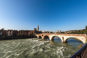 Fototapeta premium Ponte Pietra (Stone bridge), I century B.C. The oldest Roman monument in Verona, UNESCO world heritage site, and the river Adige, Veneto, Italy, Europe