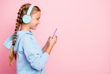 Side profile view photo of cheerful casual positive cute nice girl broswing through her phone to...