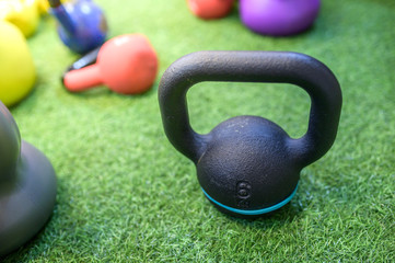 Kettlebell training on artificial grass in the gym.