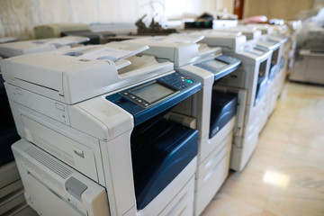 Shallow depth of field image with brand new multifunctional printers bought by a company