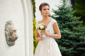 Beautiful  bride in long wedding dress with bouquet