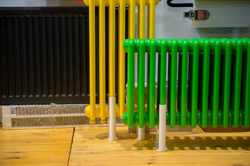 Old school classic water heaters radiators, yellow, green and black color

