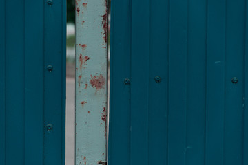Old corrugated blue metal fence