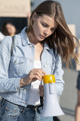 Front view woman holding a megaphone