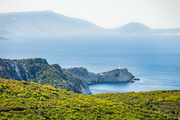 Splendid morning view of Cape Lefkatas with old lighthouse. Colorful spring seascape of Ionian Sea....