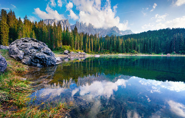 Stunning summer view of Carezza (Karersee) lake. Wonderful morning scene of Dolomiti Alps, Province of Bolzano, South Tyrol, Italy, Europe. Beauty of nature concept background.