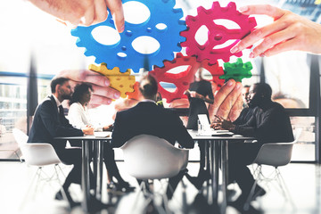 Business team connect pieces of gears. Teamwork, partnership and integration concept. double...