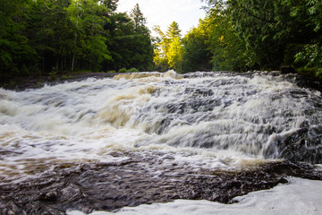 Rushing river from spring snow melt at Bond Falls in the Upper Peninsula of Michigan.