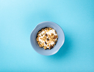 Healthy food background with homemade oatmeal granola or muesli with yogurt for healthy morning breakfast, top view, copy space. Toned photo.