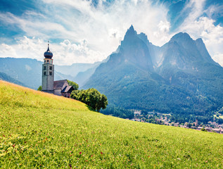 Sunny morning view of San Valentino Church in Castelrotto/Kastelruth village. Exciting summer scene...