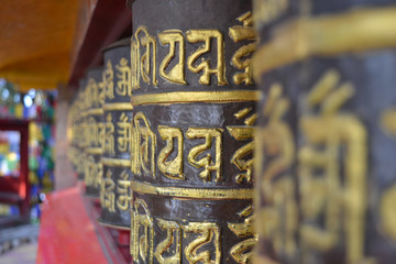 closeup of a row of Buddhist Prayer Wheels
