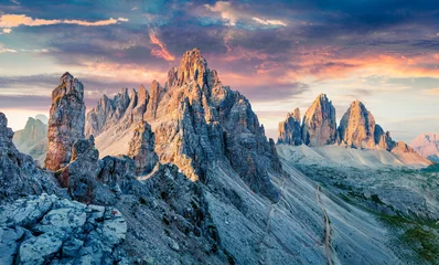Foto op Plexiglas Unbelievable morning view of Paternkofel and Tre Cime Di Lavaredo mpountain peaks. Wonderful summer sunset in Dolomiti Alps, South Tyrol, Italy, Europe. Beauty of nature concept background. © Andrew Mayovskyy