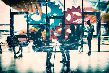 Business team connect pieces of gears. Teamwork, partnership and integration concept. double...