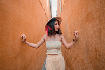 Asian women strolling in an alley in Hoi An