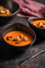 Vegetarian delicious autumn pumpkin cream soup served in beautiful rustic bowls
