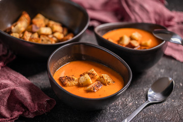 Vegetarian delicious autumn pumpkin cream soup served in beautiful rustic bowls
