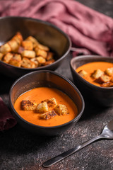 Vegetarian delicious autumn pumpkin cream soup served in beautiful rustic bowls