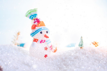 Christmas snowman with Xmas decorations on snow. Macro shot