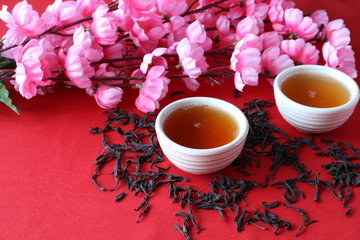 Chinese tea ceremony on the background of Sakura flowers.