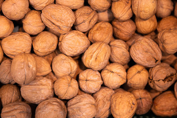 Photo of many walnuts with shells for healthy snack, may be used as background for food commercial