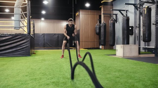 bearded man training with suspension straps 