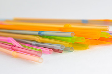 Multicolored plastic tubules on a white background