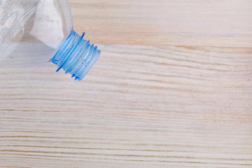 part of a plastic bottle on a wooden background