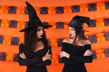 Image of offended witch women in black halloween costume and makeup