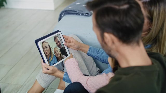 Parents with daughter watching photos on the tablet