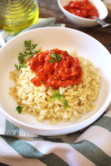 Pearl barley with tomato and bell pepper sauce, parsley dressing