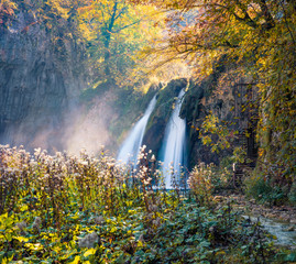Fototapeta na wymiar Sunny morning view of pure water waterfall in Plitvice National Park. Romantic autumn scene of Croatia, Europe. Abandoned places of Plitvice lakes series. Beauty of nature concept background.