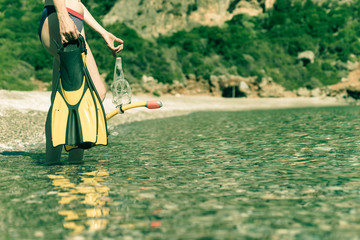 Woman with flippers snorkeling tube on beach