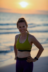 Fototapeta na wymiar fitness sports woman on seashore in evening relaxing