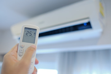 remote control air condition on hand, save power concept