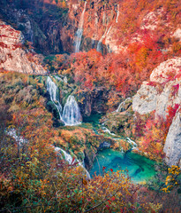 Amazing morning view of pure water waterfall in dyyp canyon. Exotic autumn scene of Plitvice National Park, Croatia, Europe. Beauty of nature concept background..
