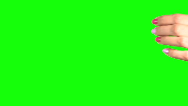 Woman pulling something virtual and invisible down. Beautiful manicured female hand isolated on green chroma key background. Real time 4k video footage.
