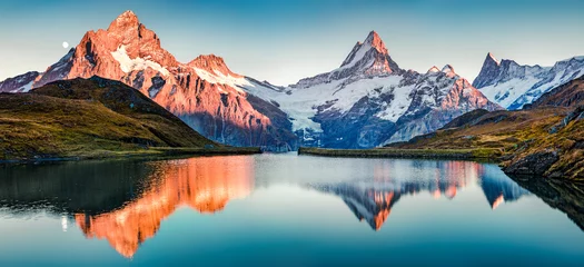 Wall murals Alps Fantastic evening panorama of Bachalp lake / Bachalpsee, Switzerland. Picturesque autumn sunset in Swiss alps, Grindelwald, Bernese Oberland, Europe. Beauty of nature concept background..