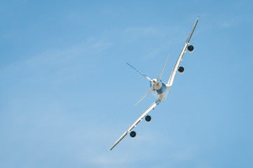 large passenger jet performing a tight banking manoeuvre 