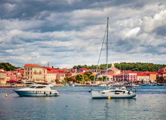 Fototapeta na wymiar Colorful morning cityscape of popular summer resort Porec. Bright spring seascape of Adriatic Sea. Great scene of Istrian Peninsula in western Croatia, Europe. Traveling concept background.