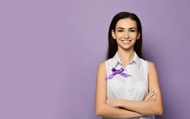 Young slim woman in white blouse with purple ribbon to epilepsy day, cancer day is smiling on purple with copy space